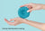 Close-up of hands holding a circular blue Manta COOL eye cup against light blue backdrop with text "Evenly-distributed cooling".